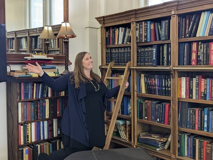 Jessica Arden on a library ladder